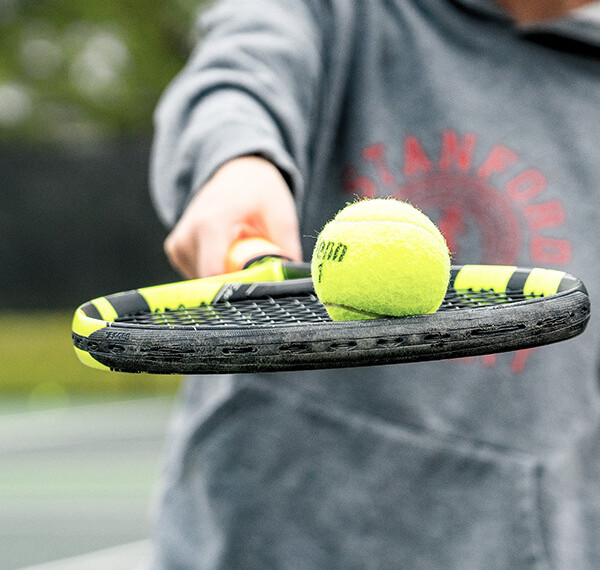 Tennis Ball being held on a tennis racket